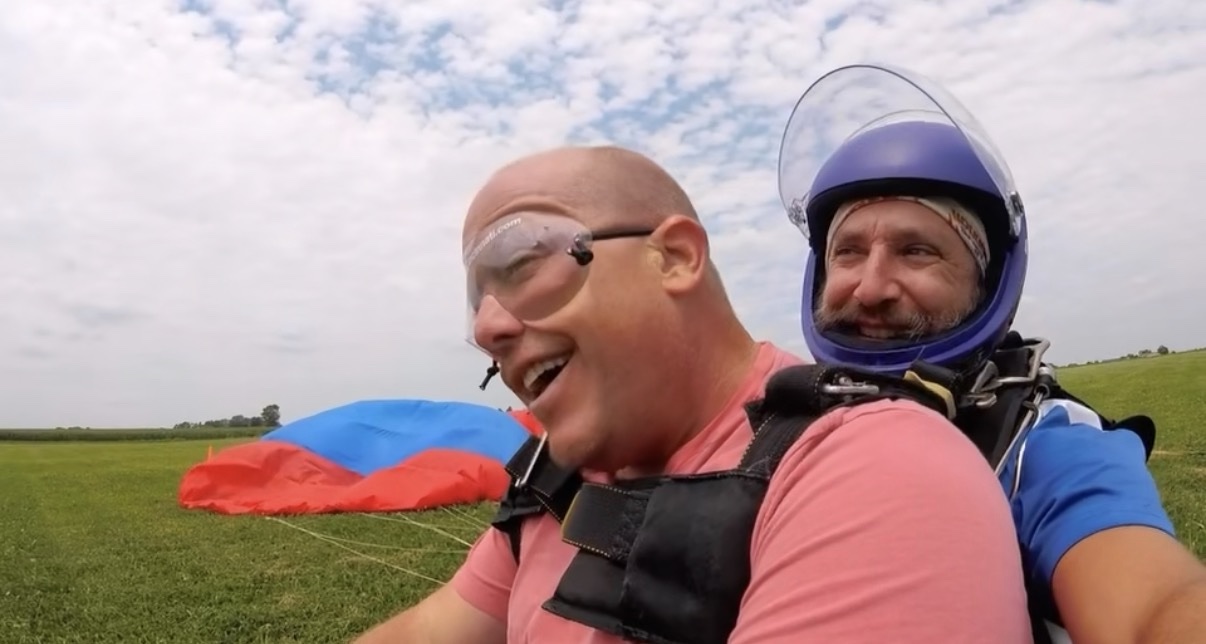 Two jumpers smiling after landing